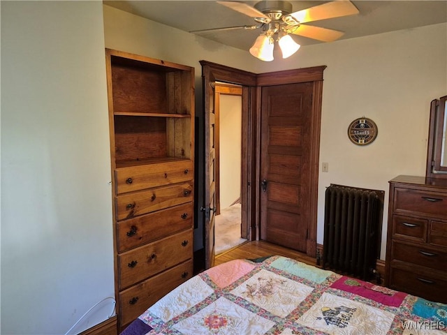 359 Utica St, Tonawanda-City, NY 14150 - bedroom with radiator, a ceiling fan, and wood finished floors
