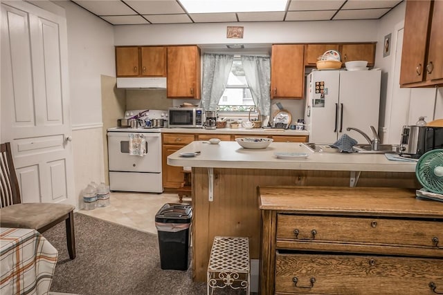 21 Washington St, Greene, NY 13778 - kitchen with white appliances, under cabinet range hood, brown cabinetry, a paneled ceiling, and light countertops