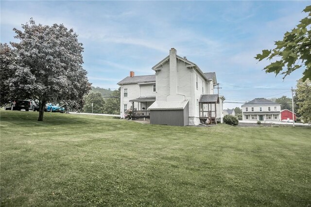 21 Washington St, Greene, NY 13778 - view of side of home featuring a chimney and a lawn