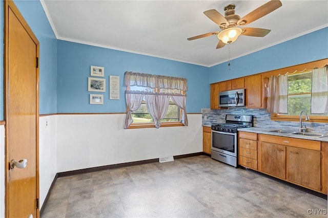 670 County Route 25th Rd Unit 25, Minetto, NY 13126 - kitchen featuring appliances with stainless steel finishes, plenty of natural light, brown cabinets, tasteful backsplash, and crown molding
