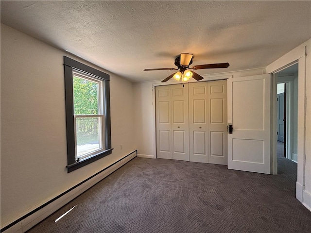19 Pratt St, Sheffield Township, PA 16347 - unfurnished bedroom with baseboard heating, dark carpet, a closet, ceiling fan, and a textured ceiling