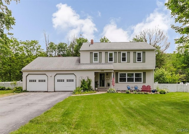5458 Oxbow Rd, Cazenovia, NY 13035 - view of front of home featuring a garage, a chimney, and asphalt driveway
