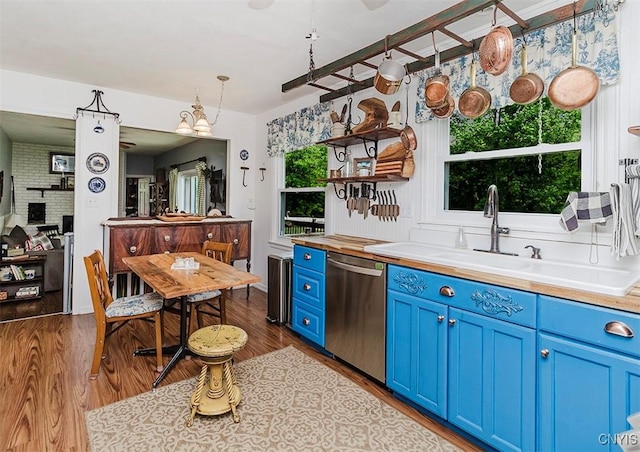 5458 Oxbow Rd, Cazenovia, NY 13035 - kitchen featuring blue cabinetry, stainless steel dishwasher, open shelves, and dark wood finished floors