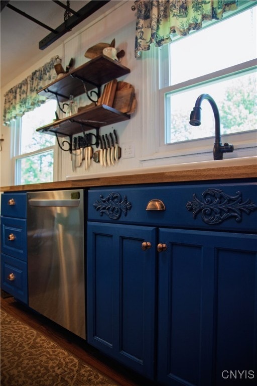 5458 Oxbow Rd, Cazenovia, NY 13035 - kitchen featuring blue cabinets, stainless steel dishwasher, plenty of natural light, and dark wood-style floors