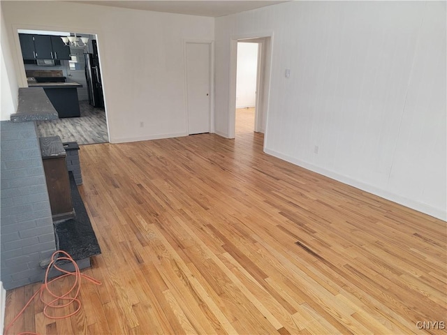 1665 State Route 31, Sullivan, NY 13037 - unfurnished living room featuring a chandelier and light wood-style flooring