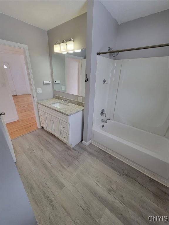1665 State Route 31, Sullivan, NY 13037 - bathroom featuring wood finished floors, washtub / shower combination, and vanity