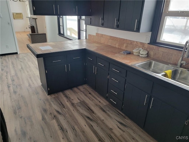 1665 State Route 31, Sullivan, NY 13037 - kitchen with a peninsula, wood finished floors, tile countertops, and blue cabinetry