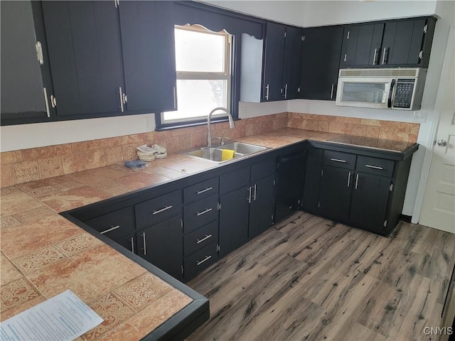 1665 State Route 31, Sullivan, NY 13037 - kitchen with stainless steel microwave, light wood finished floors, and dark cabinets
