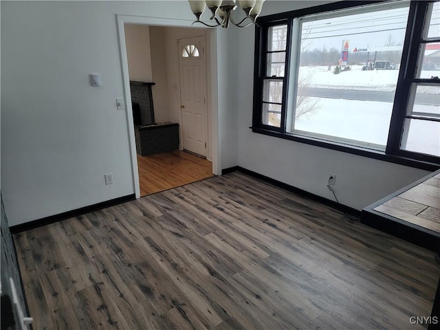1665 State Route 31, Sullivan, NY 13037 - unfurnished dining area featuring wood finished floors, a chandelier, and a fireplace