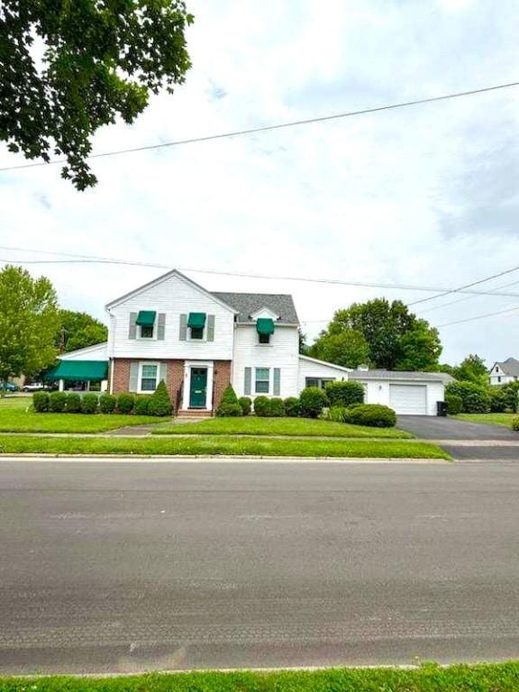 119 Platt St, Erwin, NY 14870 - view of property featuring brick siding, a front lawn, and a detached garage