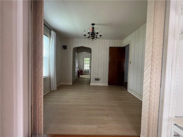 119 Platt St, Erwin, NY 14870 - unfurnished dining area featuring arched walkways, light wood-type flooring, and a chandelier