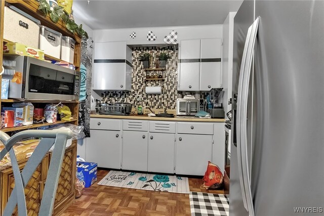 2125 Seneca Ave, Niagara Falls, NY 14305 - kitchen with appliances with stainless steel finishes, white cabinetry, and tasteful backsplash
