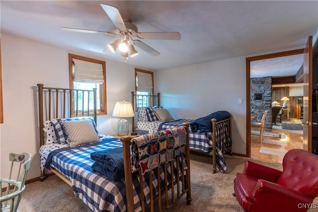 1664 S Ivy, Lysander, NY 13027 - carpeted bedroom with a ceiling fan and a fireplace