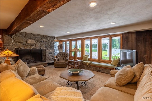 1664 S Ivy, Lysander, NY 13027 - carpeted living room featuring plenty of natural light, a stone fireplace, recessed lighting, and beam ceiling