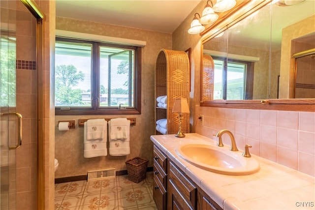 1664 S Ivy, Lysander, NY 13027 - full bath with healthy amount of natural light, a shower stall, vanity, and tasteful backsplash