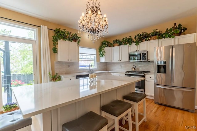 8228 Dampier Cir, Clay, NY 13090 - kitchen featuring appliances with stainless steel finishes, light countertops, and backsplash