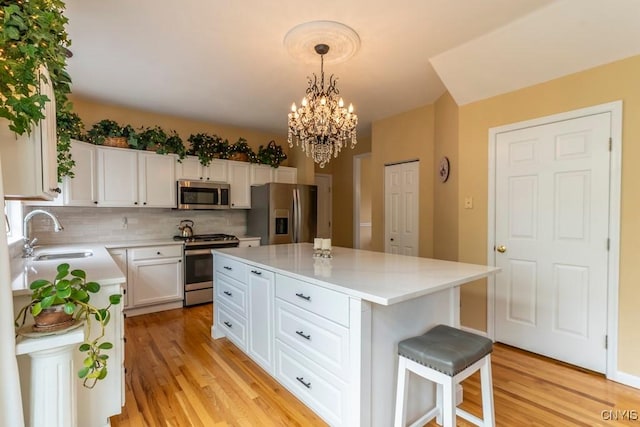 8228 Dampier Cir, Clay, NY 13090 - kitchen with stainless steel appliances, light wood-style flooring, light countertops, and white cabinets