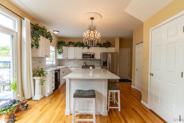 8228 Dampier Cir, Clay, NY 13090 - kitchen featuring stainless steel appliances, white cabinets, decorative backsplash, and light countertops