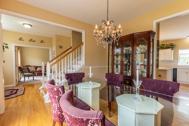 8228 Dampier Cir, Clay, NY 13090 - dining area featuring light wood finished floors, stairs, and a chandelier