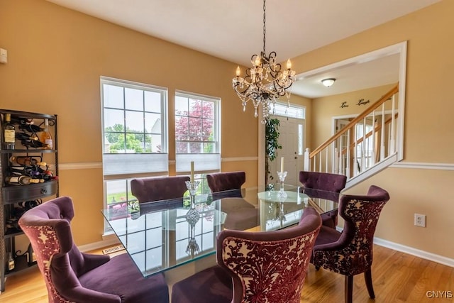 8228 Dampier Cir, Clay, NY 13090 - dining room featuring wood finished floors, a chandelier, and stairway