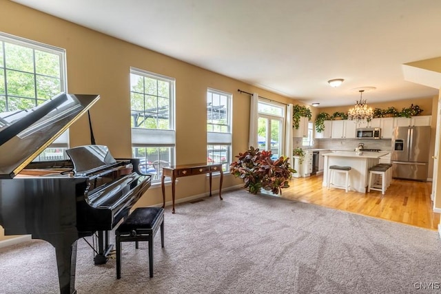 8228 Dampier Cir, Clay, NY 13090 - sitting room featuring plenty of natural light, light colored carpet, and a chandelier