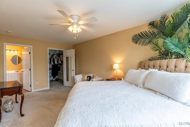 8228 Dampier Cir, Clay, NY 13090 - bedroom with light colored carpet, a walk in closet, ensuite bathroom, a ceiling fan, and a closet