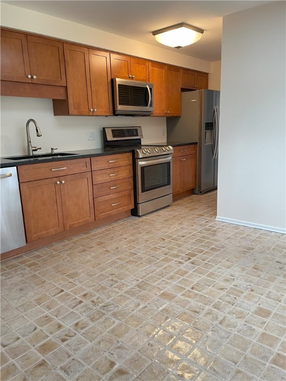 75 Towpath Ln, Brighton, NY 14618 - kitchen with appliances with stainless steel finishes, brown cabinetry, and dark countertops