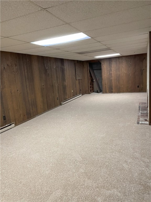 75 Towpath Ln, Brighton, NY 14618 - finished below grade area featuring a baseboard heating unit, wood walls, carpet floors, and a drop ceiling