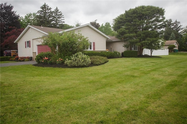 75 Towpath Ln, Brighton, NY 14618 - view of side of property with an attached garage, a lawn, and driveway