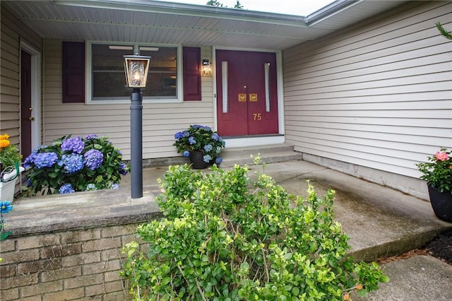 75 Towpath Ln, Brighton, NY 14618 - view of exterior entry featuring a porch