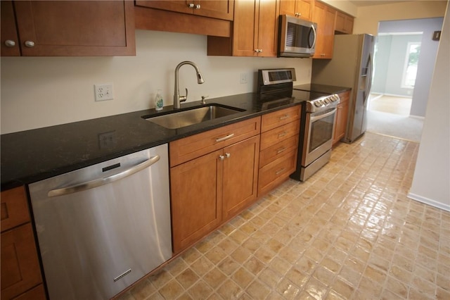 75 Towpath Ln, Brighton, NY 14618 - kitchen with stainless steel appliances, brown cabinetry, and dark countertops