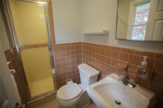 75 Towpath Ln, Brighton, NY 14618 - bathroom with tile walls, a stall shower, and a wainscoted wall