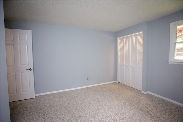 75 Towpath Ln, Brighton, NY 14618 - unfurnished bedroom with light colored carpet, a closet, and a textured ceiling