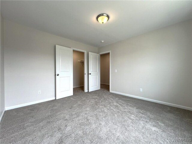 122 Winterbrook Dr, Amherst, NY 14228 - unfurnished bedroom featuring carpet, a walk in closet, and a closet