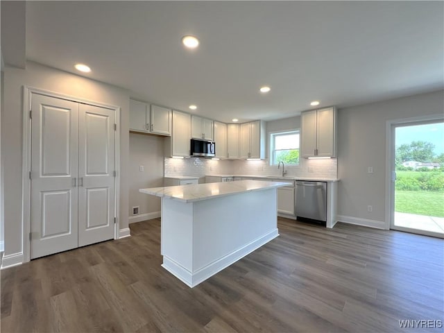 122 Winterbrook Dr, Amherst, NY 14228 - kitchen featuring appliances with stainless steel finishes, dark wood-style flooring, backsplash, white cabinetry, and recessed lighting
