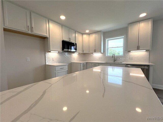 122 Winterbrook Dr, Amherst, NY 14228 - kitchen featuring dishwasher, light stone countertops, backsplash, and recessed lighting
