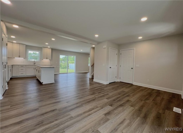 122 Winterbrook Dr, Amherst, NY 14228 - unfurnished living room with recessed lighting, dark wood-type flooring, and stairs