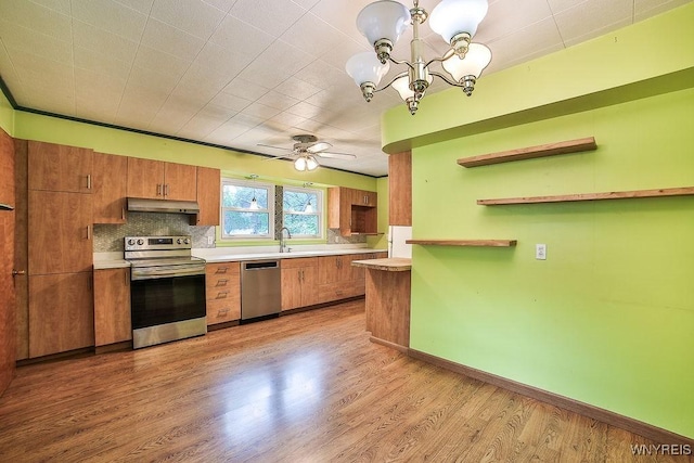 425 Tryon Dr, Lewiston, NY 14092 - kitchen featuring appliances with stainless steel finishes, open shelves, under cabinet range hood, brown cabinetry, and light wood-style flooring