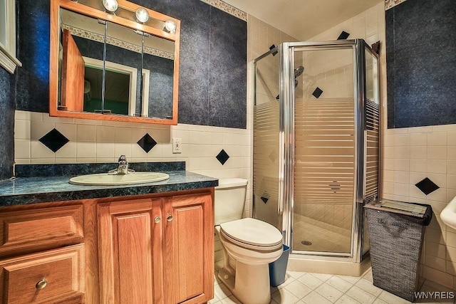 425 Tryon Dr, Lewiston, NY 14092 - bathroom with tile walls, tile patterned flooring, vanity, a shower stall, and wainscoting