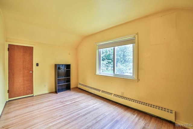 425 Tryon Dr, Lewiston, NY 14092 - additional living space featuring a baseboard radiator, vaulted ceiling, and wood finished floors