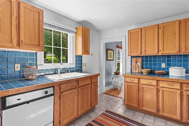 1870 Carey Rd, Franklin, NY 13775 - kitchen with white dishwasher, tile countertops, light tile patterned floors, and tasteful backsplash
