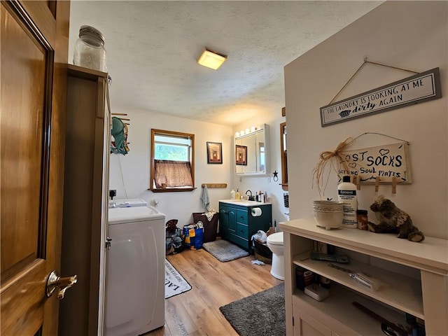 2313 Stickle Rd, Addison, NY 14801 - bathroom with washer / clothes dryer, wood finished floors, a textured ceiling, and vanity