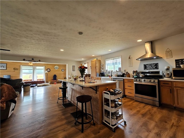 2313 Stickle Rd, Addison, NY 14801 - kitchen featuring appliances with stainless steel finishes, wall chimney exhaust hood, plenty of natural light, a breakfast bar area, and recessed lighting