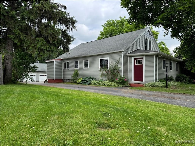 11052 S Lake Rd, Pavilion, NY 14525 - view of front of property with a front lawn, a detached garage, a shingled roof, and entry steps