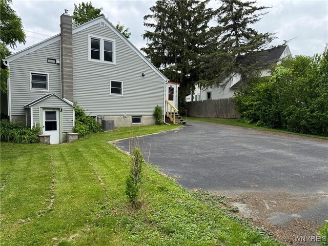 11052 S Lake Rd, Pavilion, NY 14525 - view of home's exterior featuring a chimney, asphalt driveway, and entry steps