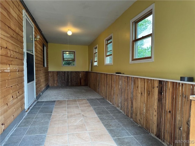 11052 S Lake Rd, Pavilion, NY 14525 - corridor featuring wooden walls, healthy amount of natural light, a wainscoted wall, and tile patterned flooring