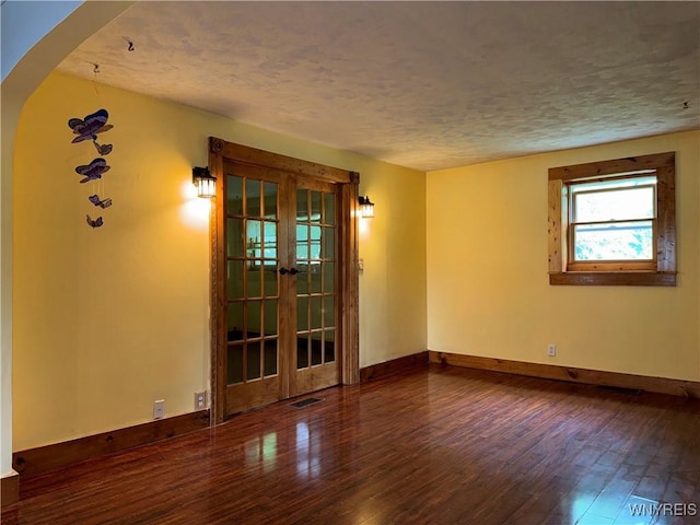 11052 S Lake Rd, Pavilion, NY 14525 - unfurnished room featuring wood-type flooring, french doors, arched walkways, and a textured ceiling