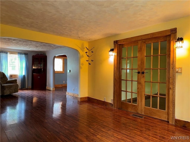 11052 S Lake Rd, Pavilion, NY 14525 - unfurnished living room with arched walkways, healthy amount of natural light, a textured ceiling, and wood finished floors