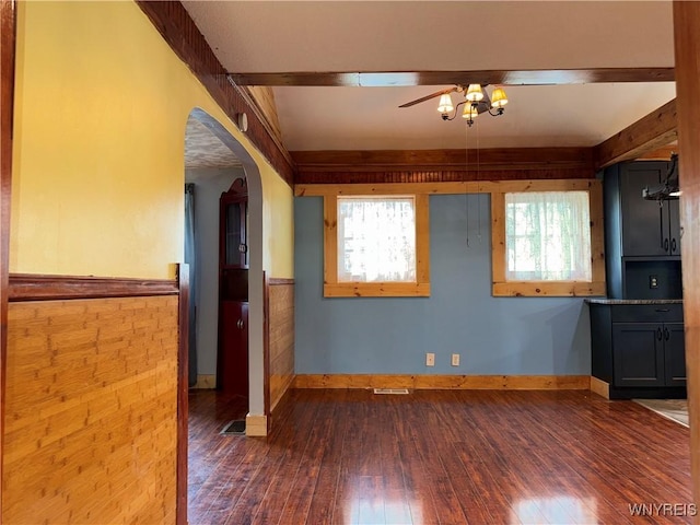 11052 S Lake Rd, Pavilion, NY 14525 - unfurnished living room with wainscoting, arched walkways, dark wood-style floors, and a ceiling fan