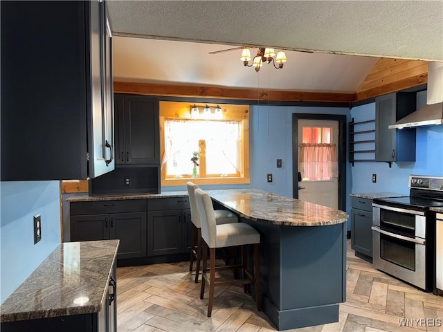 11052 S Lake Rd, Pavilion, NY 14525 - kitchen with double oven range, wall chimney exhaust hood, vaulted ceiling, stone counters, and a kitchen breakfast bar